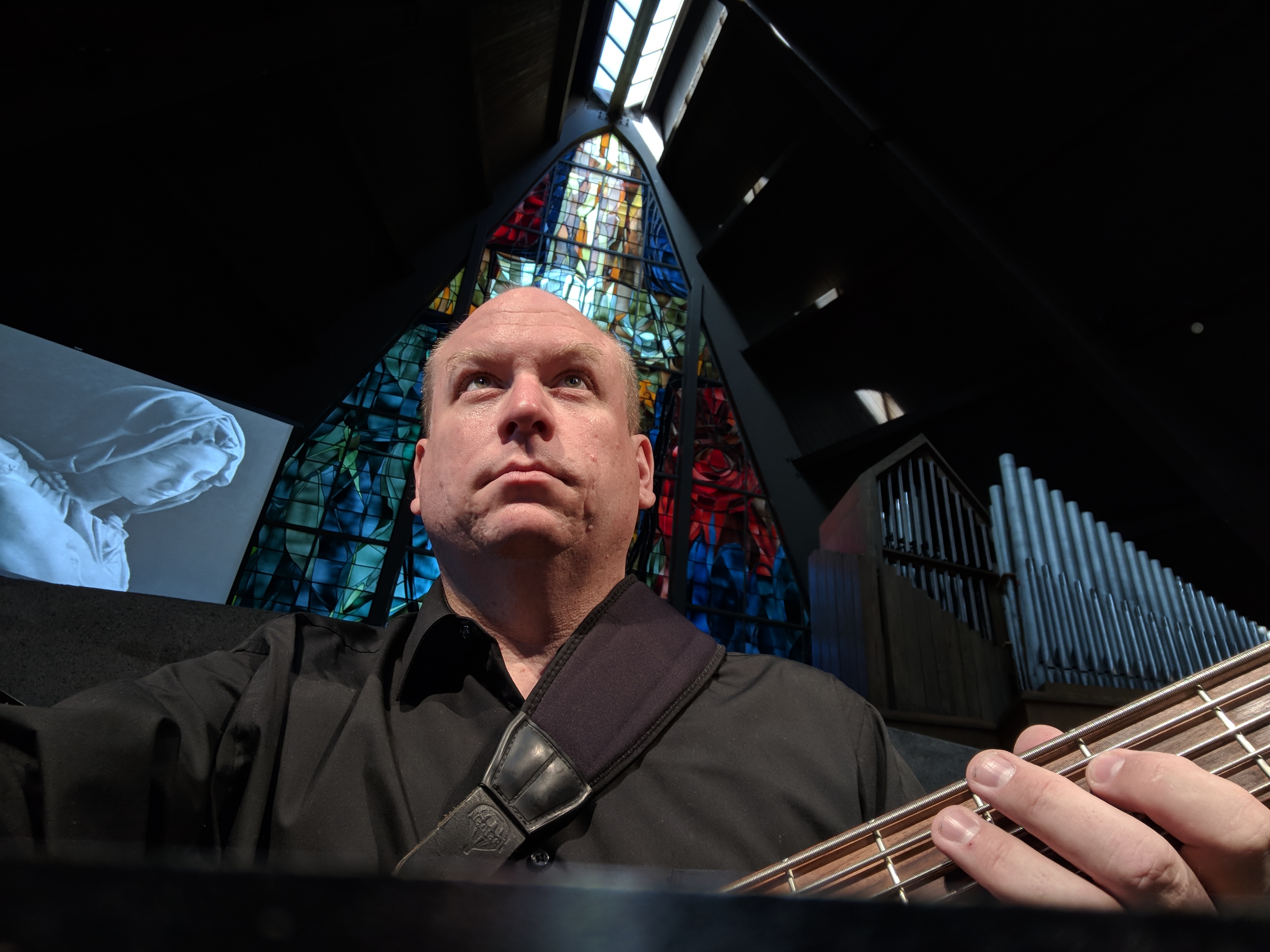 Phillip B. Pacier performing electric bass in a concert setting