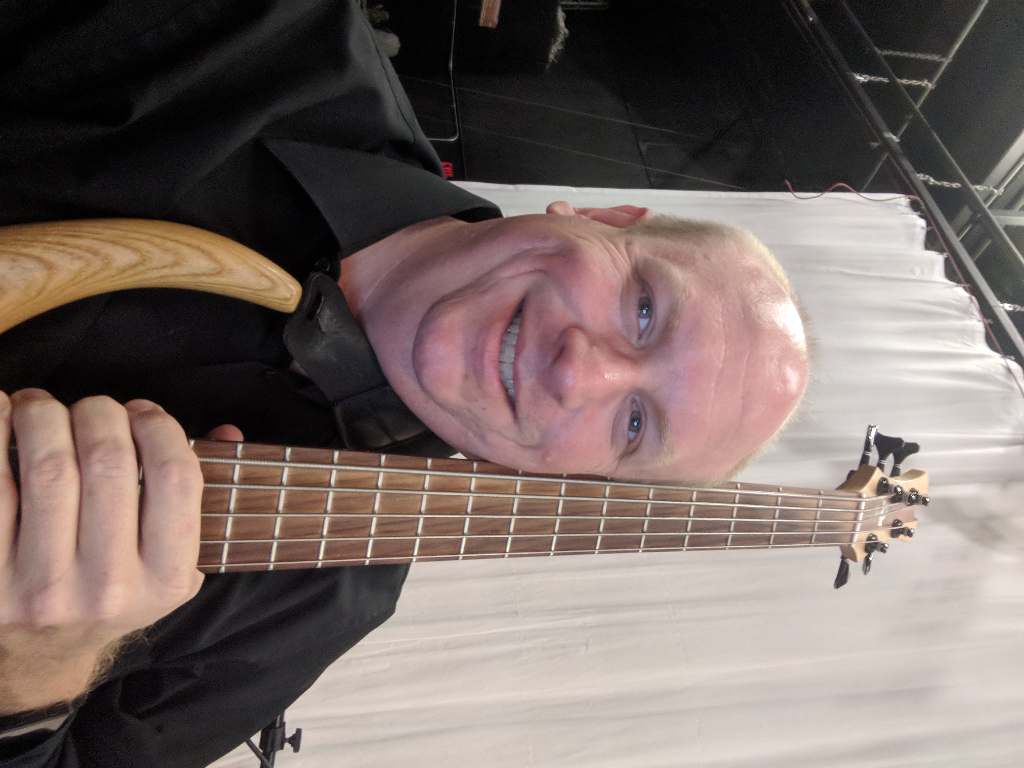 Electric bass, amplifier, music stand, and score prepared for an ensemble performance