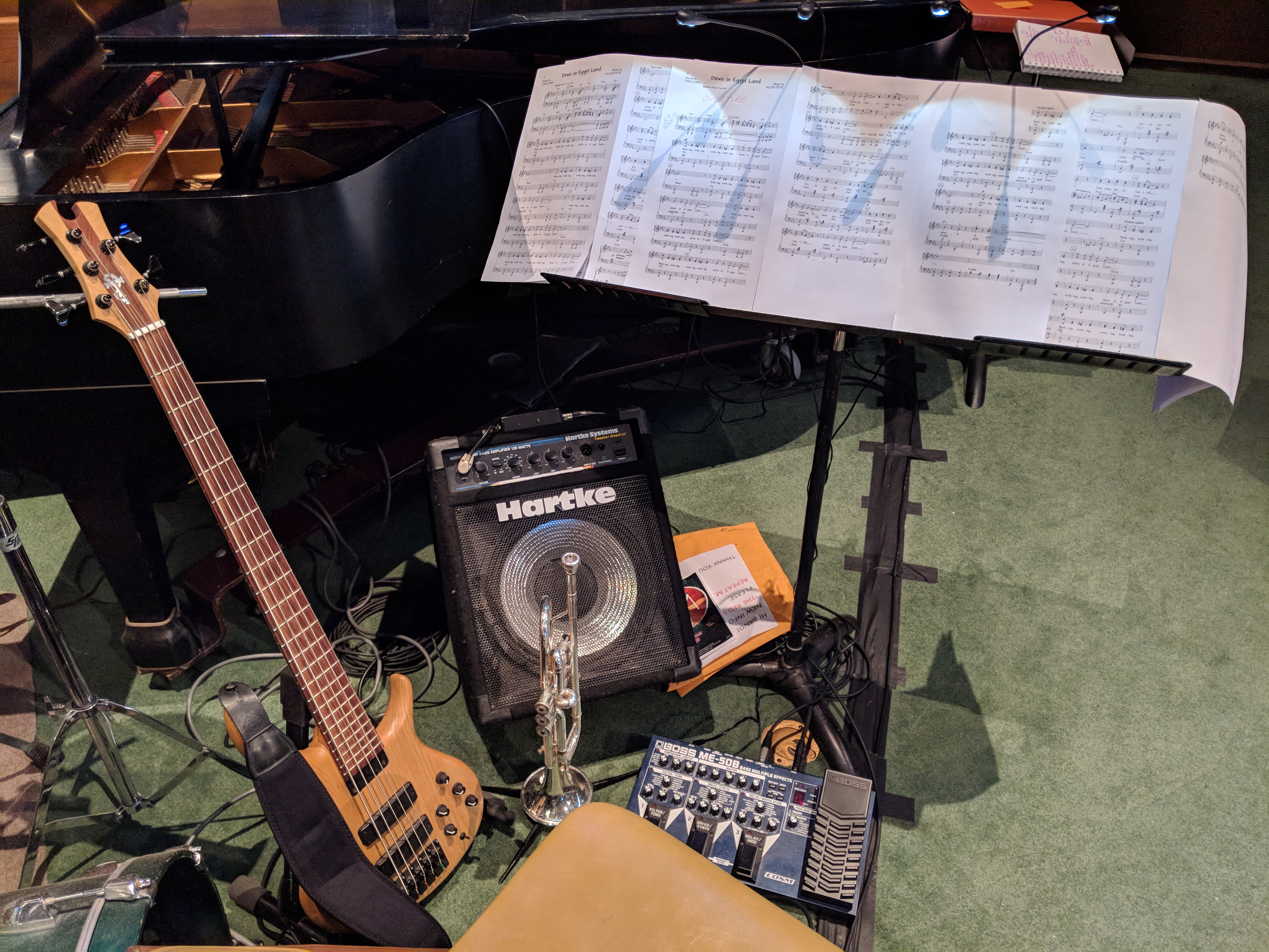 Electric bass and trumpet prepared beside a music stand and score